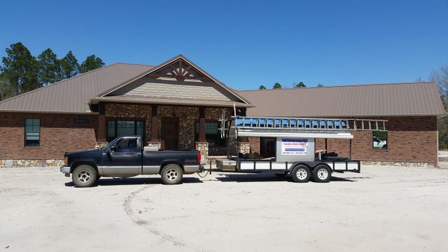 G&L Aluminum's work truck parked in front of a commercial gutter system clients store front.