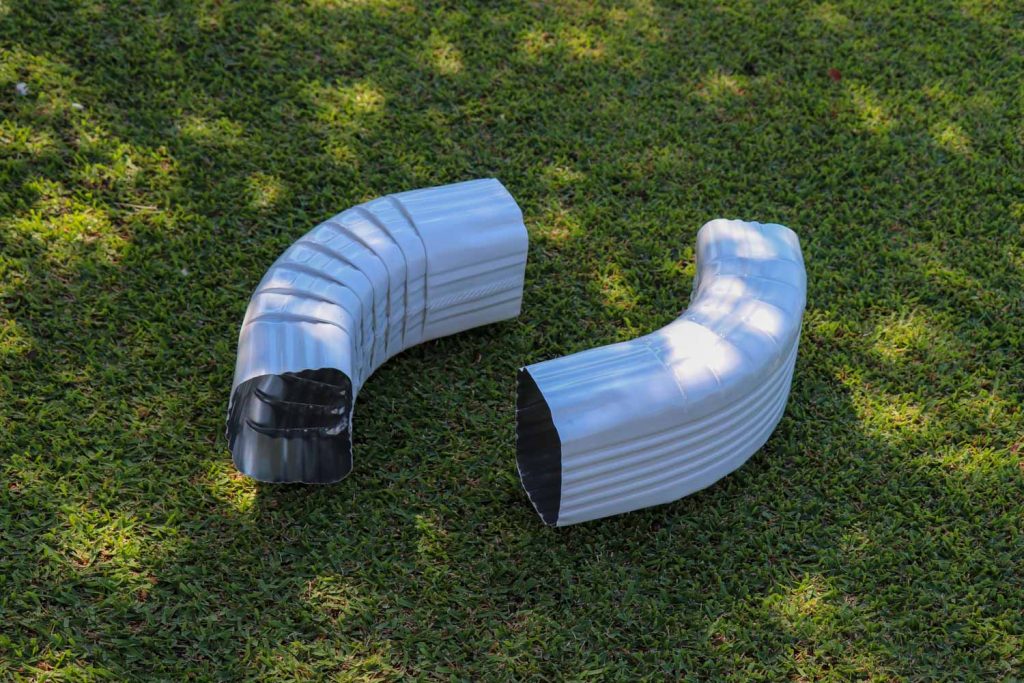 Two white 6-inch rain gutter elbow joints